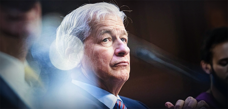 Jamie Dimon, Chairman and CEO of JPMorgan Chase &amp; Co, sits in a congressional-style hearing, his expression tense and reflective, with dramatic lighting and blurred figures underscoring the gravity of ongoing economic warnings.